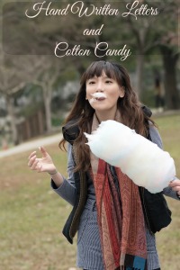 Young Asian woman eating cotton candy in outdoor.